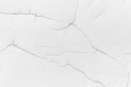 White plaster wall with cracks texture background.の写真素材