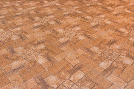 Brown tile floor with abstract pattern of stone surface texture background.の写真素材