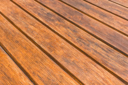 Diagonal texture brown wooden table surface boards background.の写真素材