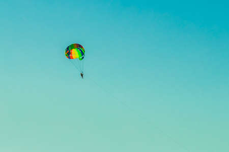 A man and a woman tourists are parachuting against the blue sky. Extreme vacation concept.の写真素材
