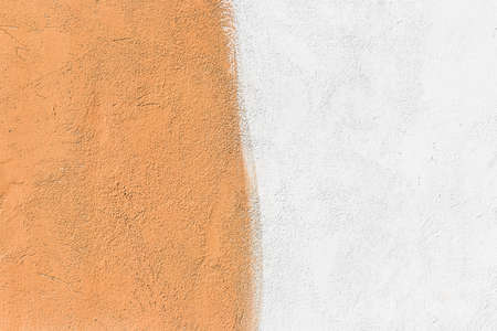 Wall two colors: light brown and white paint on concrete surface texture background.の写真素材