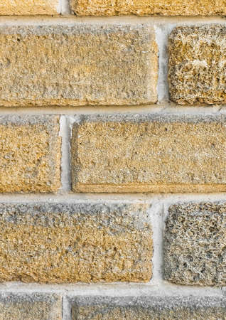 Part of modern wall interior with brick shell limestone blocks texture background.の写真素材