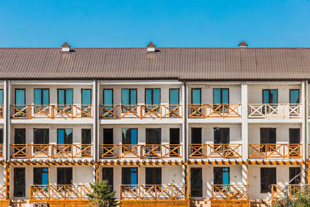 Modern standing apartments in the resort area of the hotel near the sea against the blue sky.の写真素材