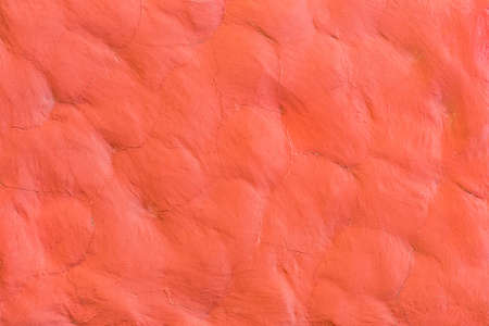 Red paint on the stone surface wall texture background.の写真素材