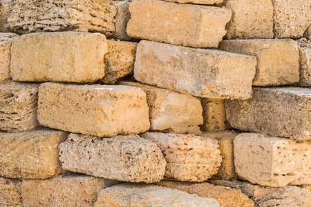 Heap of brick shell blocks sand stone texture background, close-up.の写真素材