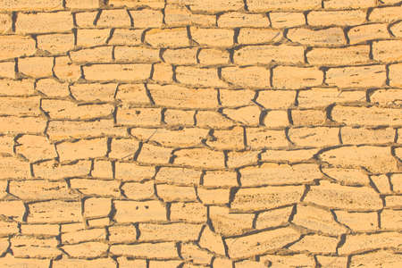 Sand color light yellow old stone brick wall ancient texture background.の写真素材