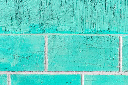 Aquamarine or azure paint on the wall of brick blocks with cracked texture background.の写真素材