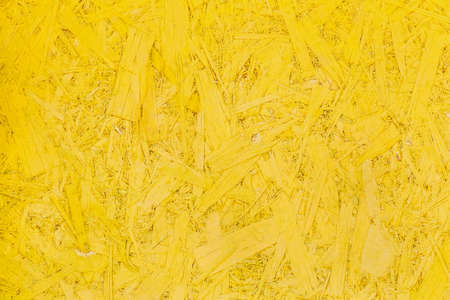 Yellow pressed wood texture, chipboard light surface background.の写真素材