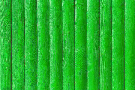 Green paint on fence boards surface wooden texture background.の写真素材