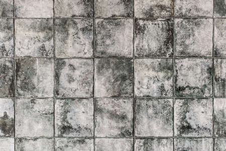 Dark gray square ceramic floor tiles with abstract pattern, mosaic texture background.の写真素材