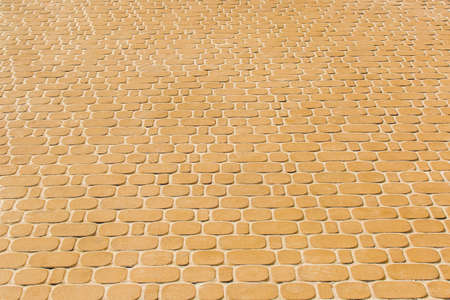 Light orange or yellow stone paving slabs floor tile urban texture background.の写真素材