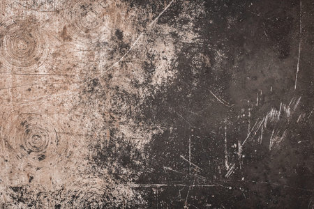 Old scratched metal texture, dirty dark background.