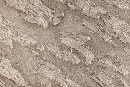 Texture of a gray wall with abstract decorative stucco patterns, plaster background.