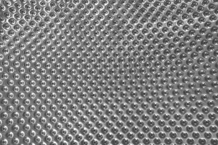 Metal silver gray surface of the drum of a washing machine with a round abstract pattern texture...