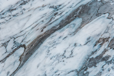 Blue and white marble slab texture of ceramic floor tiles with abstract pattern background.