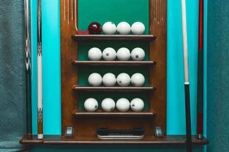 Shelf with white balls and billiards equipment.の写真素材