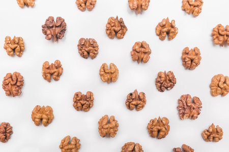 Inner halves of peeled walnut on a white background isolated.