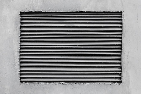 The ventilation grille is mounted in the gray wall of the transformer box background.