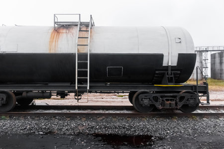 Dirty railway tank car with fertilizers or chemical products after unloading at an industrial plant.