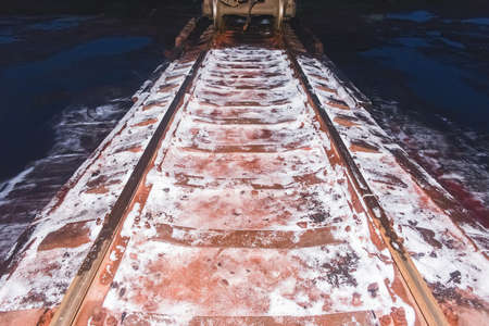 The remains of white ammonium nitrate, fertilizers when unloading a wagon on railway tracks.の写真素材