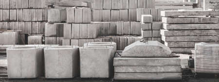 Storage of concrete blocks in a warehouse. Concrete structures at the construction site. Industrial, building cement materials.の写真素材