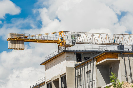 Belarus, Minsk - May 28, 2020: Tower crane and urban modern building under construction at a...