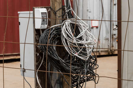 A pile of wires, an electric lighting power system on the background of a construction site, close-up.の写真素材