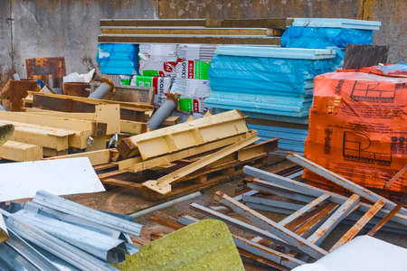 Belarus, Minsk region - December 11, 2019: Storage of a pile of different industrial debris and waste in the open area of the construction site.のeditorial素材