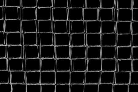 A pile of metal plates and square industrial pipes texture background. Building materials at the construction site.の写真素材