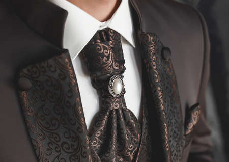 Luxurious brown men's suit with patterns and a tie, white shirt close-up.の写真素材