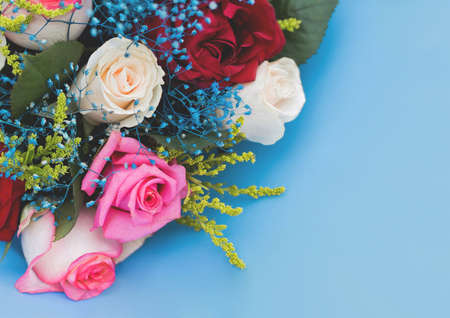 Decorative wedding bouquet of roses flowers on a blue background.の写真素材