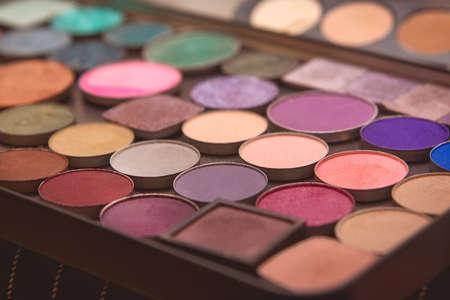 Multi-colored eye and makeup palette shades, women's cosmetics close-up.の写真素材