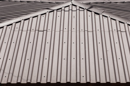 Metal roof covering of the house iron structure and architecture texture background.