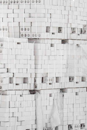 Building brick silicate white blocks material is packed and stored outdoors on an industrial site.の写真素材