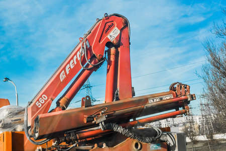 Belarus, Minsk - December 19, 2019: Machine crane on a background of blue sky and city.のeditorial素材