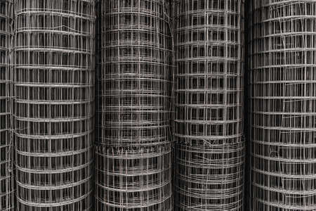 Metal square grid in rolls, steel wire texture, netting fence surface, building material.の写真素材