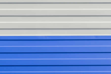 Blue and White Painted Sheet Metal Plates Iron Fence Texture Background.の写真素材
