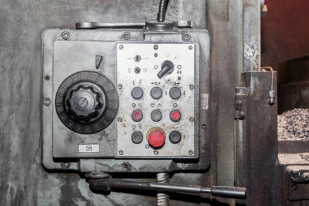 Old system with power and buttons control panel of industrial equipment in the factory.