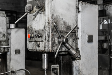 Part of an old milling machine of equipment and tools for metalworking with an iron handle in the...
