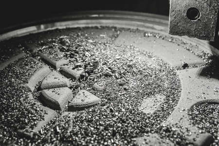 Chips after processing the cast iron hatch on the carousel machine in the workshop of the industrial plant.の写真素材