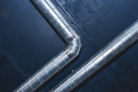 Ventilation pipe system at the ceiling of an industrial enterprise or plant premises.の写真素材