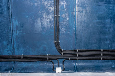 Industrial cable power connection and insulation of electrical wires installation of electricity line on the wall.の写真素材