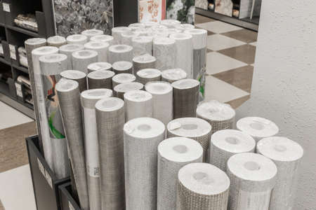 A bunch of light rolls of wallpaper paper in the hardware store materials for repair.の写真素材