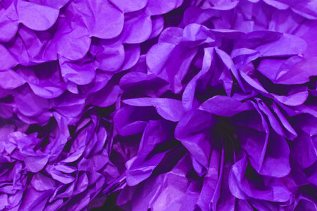 Old purple crumpled pieces in a pile of paper background.