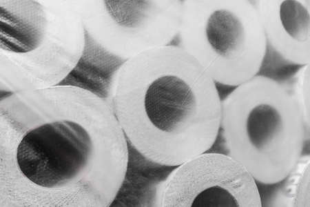 Rolls of toilet paper, packed in cellophane film, background.の写真素材