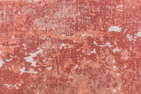 Red old peeling paint with concrete or cement surface dirty wall texture background.