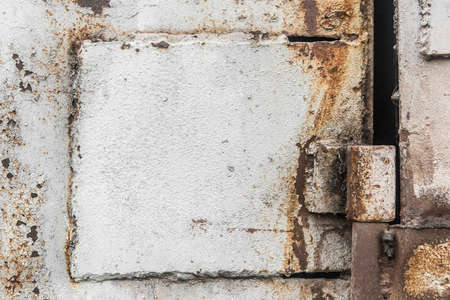 Old door installation system welded point hinge, dirty iron worn plates.の写真素材