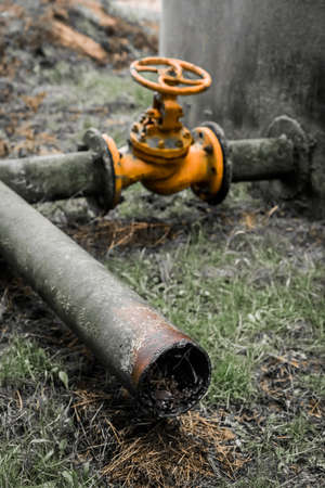 Old valve for opening or shutting down ammonia water pipeline for fuel oil chemical tanks in an abandoned industrial plant.の写真素材