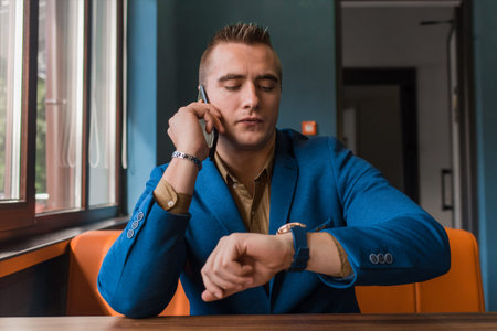 A man of stylish European appearance portrait of a businessman in a jacket talks on a mobile phone...