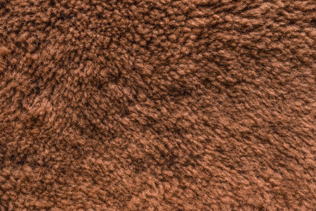 Brown natural fur or wool surface texture animal skin background.